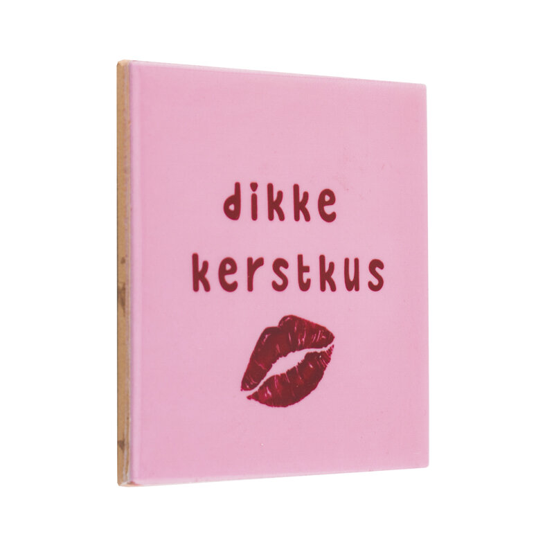 Roze keramieken tegeltje met tekst &quot;Dikke Kerstkus&quot; en lippenafdruk &ndash; schuin zijaanzicht.